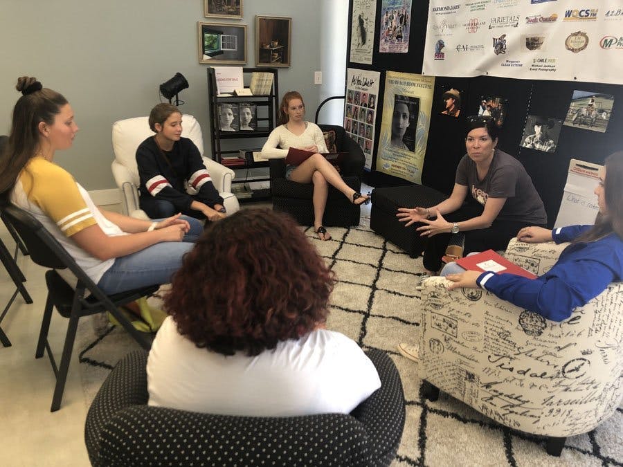 Five teens sitting in a circle at Teen Nature Journaling workshop